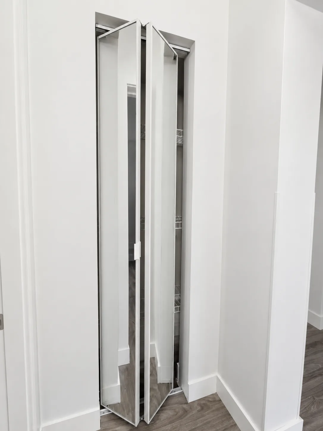 Mirrored bifold closet door in a hallway