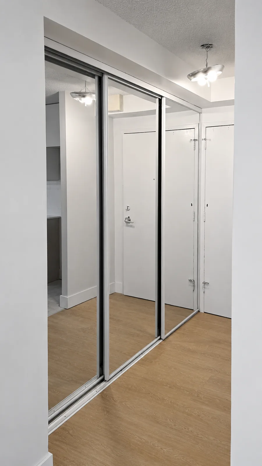 Mirrored bypass closet doors in an entryway
