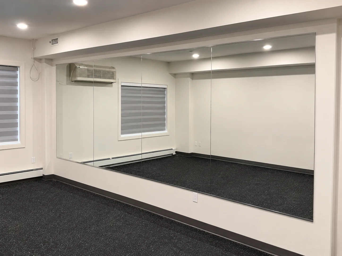 Wide wall mirror in a home gym studio