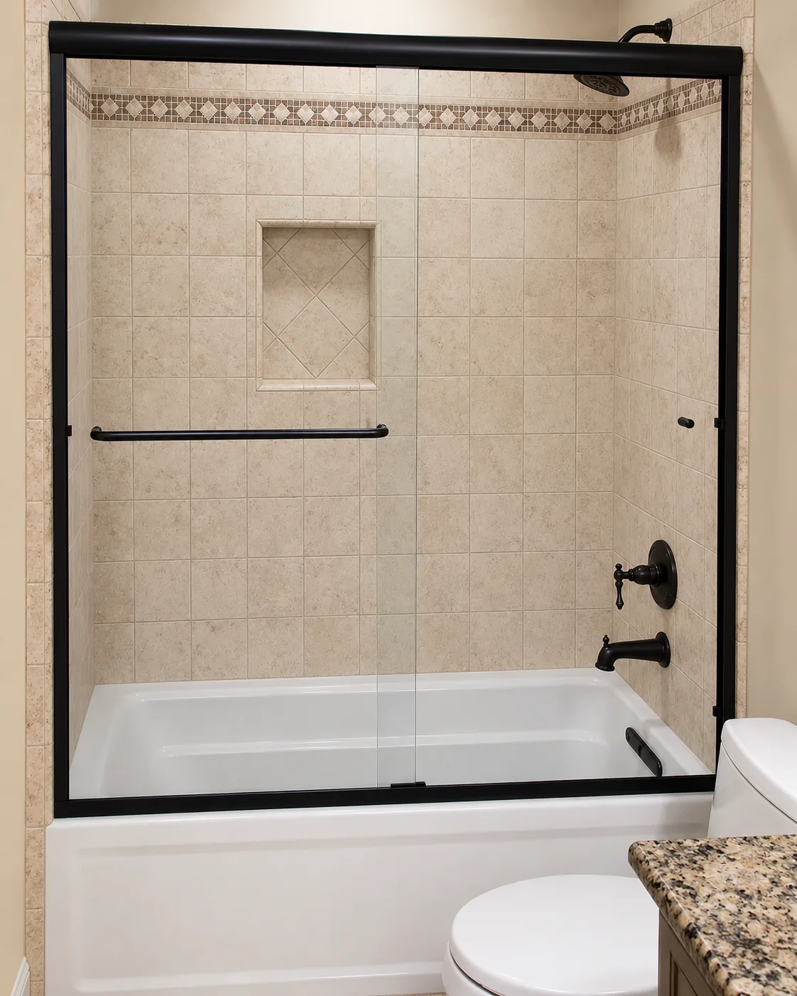 Framed black sliding tub door with tile niche