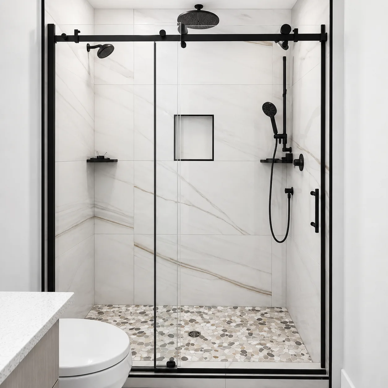 Black-framed sliding shower door on a marble surround
